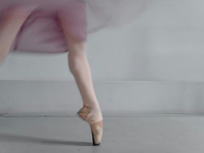 Blurred motion of a person performing a gentle stretch.